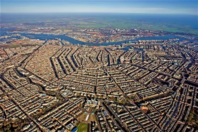 Amsterdam canal belt with historic canal houses and trees seen from above