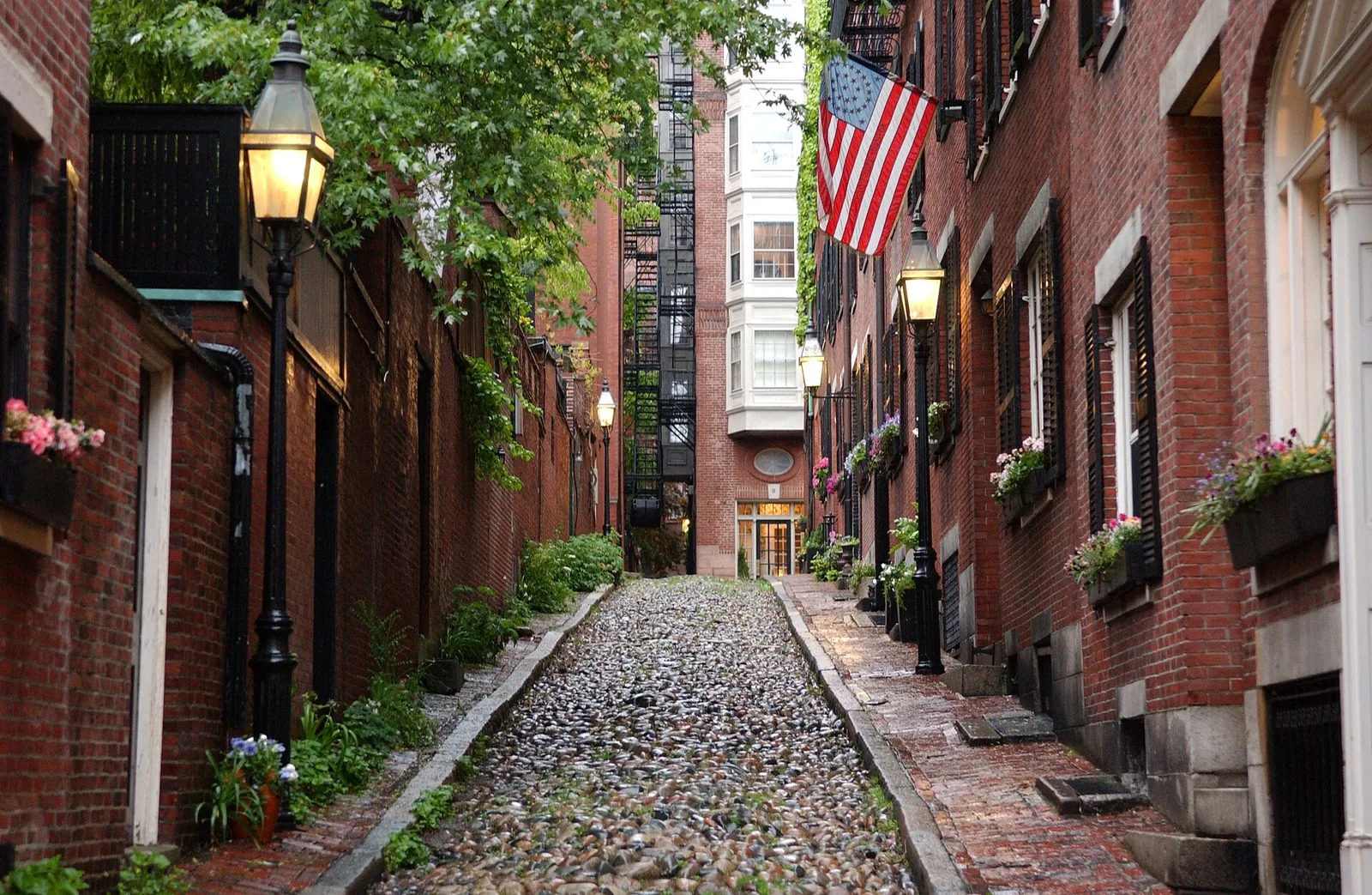 Cobbled lane lined with historic brick houses and lanterns in Beacon Hill, Boston