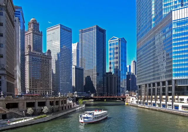 Chicago River and riverfront towers with a sightseeing boat