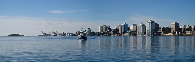 Halifax waterfront skyline across the harbour with a passenger ferry